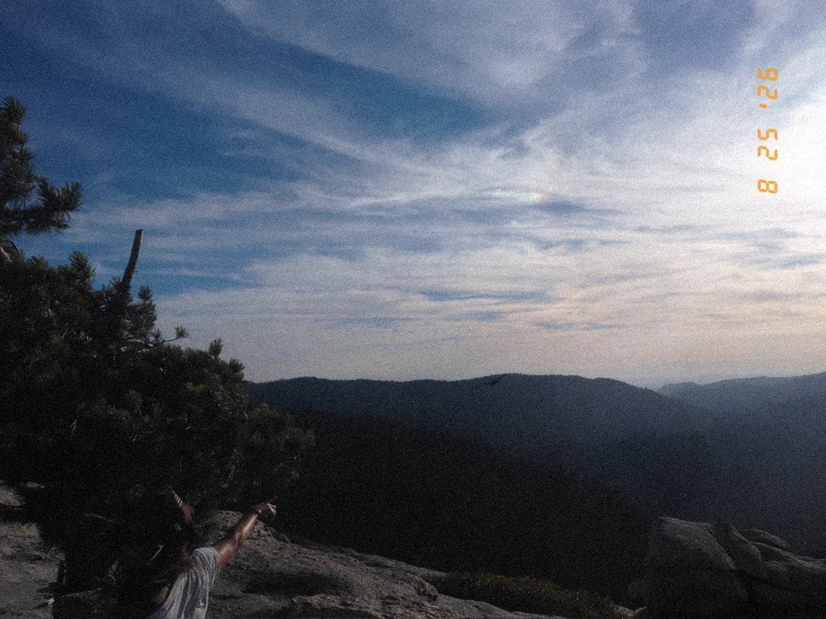 High wispy cirrus over ridge after ridge of hills, the light going out of the day.